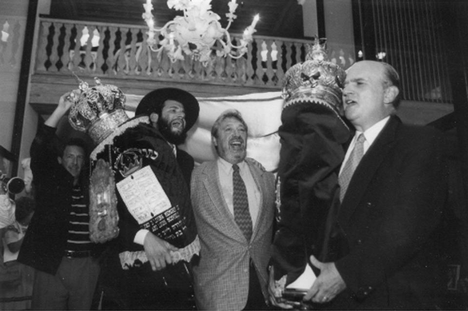 Richard Zaretsky, Rabbi Moshe Scheiner, Hazan David Feuer and Michael Gelfand carry Torahs while leaving the Palm Beach Hotel in 1999. The hotel was the former location of the Palm Beach Synagogue.