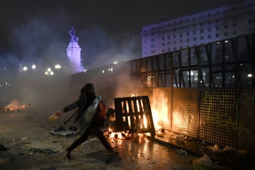 A woman throws a bottle at riot police outside the National Congress in Buenos Aires in 2018 after senators rejected the bill to legalize abortion