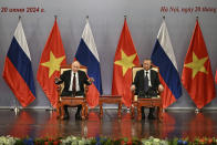 Russia's President Vladimir Putin, left, and Vietnam's President To Lam attend an event attended by the Vietnam Friendship Association and generations of Vietnamese alumni that studied in Russia at the Hanoi Opera House in Hanoi, Thursday June 20, 2024. (Manan Vatsyayana, Pool Photo via AP)