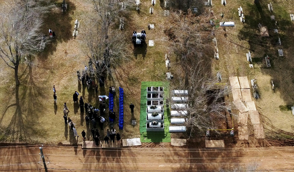 In this image taken with a drone, the graveside service for the Earl-Haight funeral is held at the cemetery in on Friday, Jan. 13, 2023, in La Verkin, Utah. Tausha Haight, her mother, Gail Earl, and her five children were shot and killed by her husband Jan. 4. (Scott G Winterton/The Deseret News via AP)