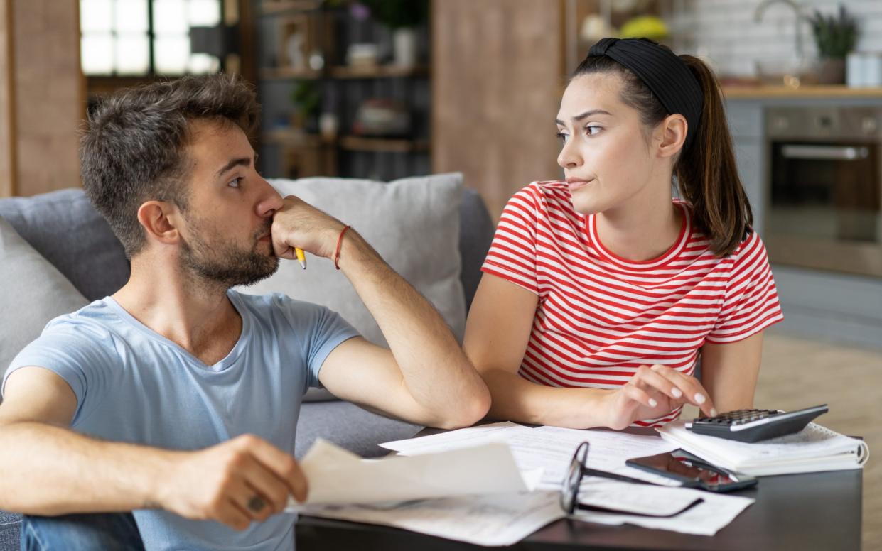 A couple looking concerned at their house being down valued