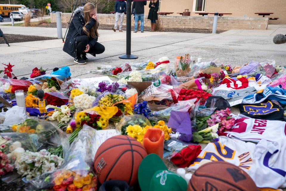 A woman pays tribute at a Kobe Bryant memorial following the sportsman's death (AP)