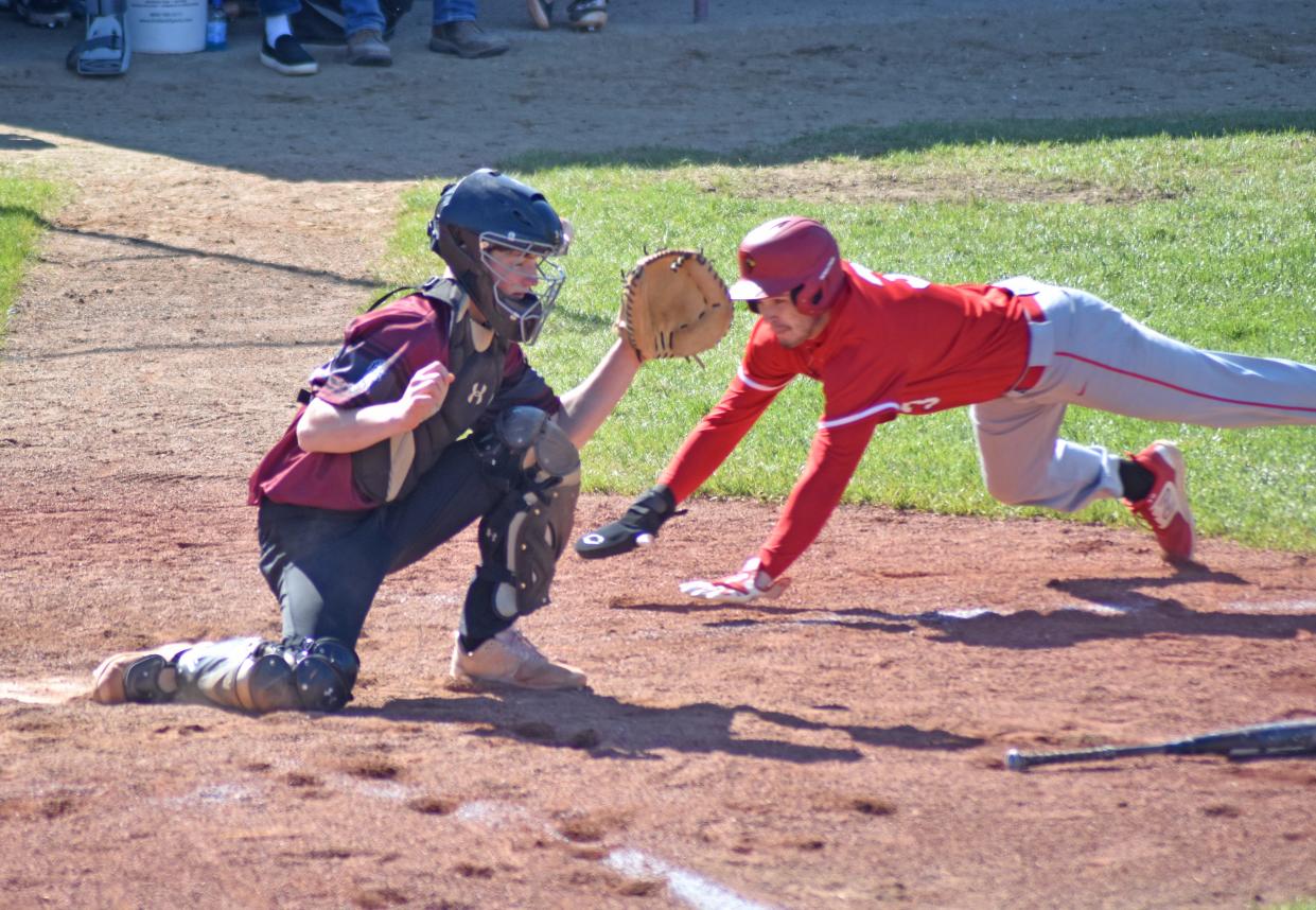 Coldwater's Matthew Nichols (3) scores on a play at the plate while Union City catcher Tucker Zweng awaits the throw