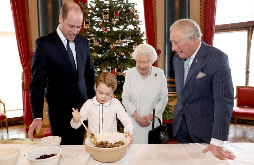 <p>In a photo showcasing four generations of royals, Prince George helps cook a Christmas pudding with Prince William, Prince Charles, and the Queen.</p>