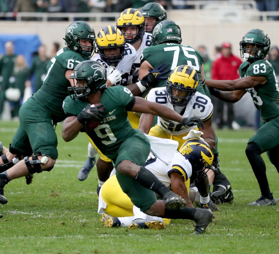 Michigan State Spartans running back Kenneth Walker III (9) runs for a first down against the Michigan Wolverines during second half action Saturday, Oct. 30, 2021.  