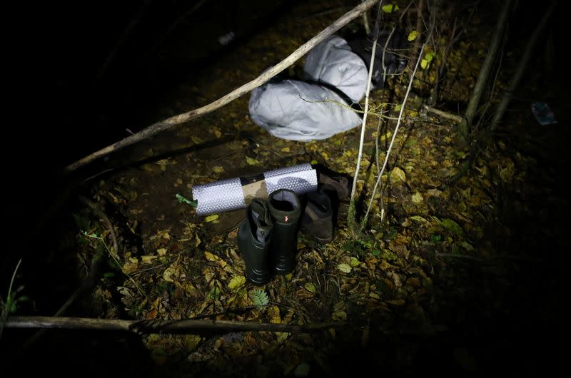 Belongings of group of migrants after they cross Belarusian-Polish border are pictured in the woods near Sokolka