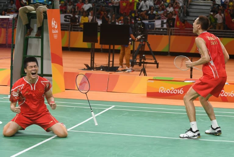 Zhang Nan (right) and Fu Haifeng celebrate winning the men's badminton doubles gold medal in Rio on August 19, 2016