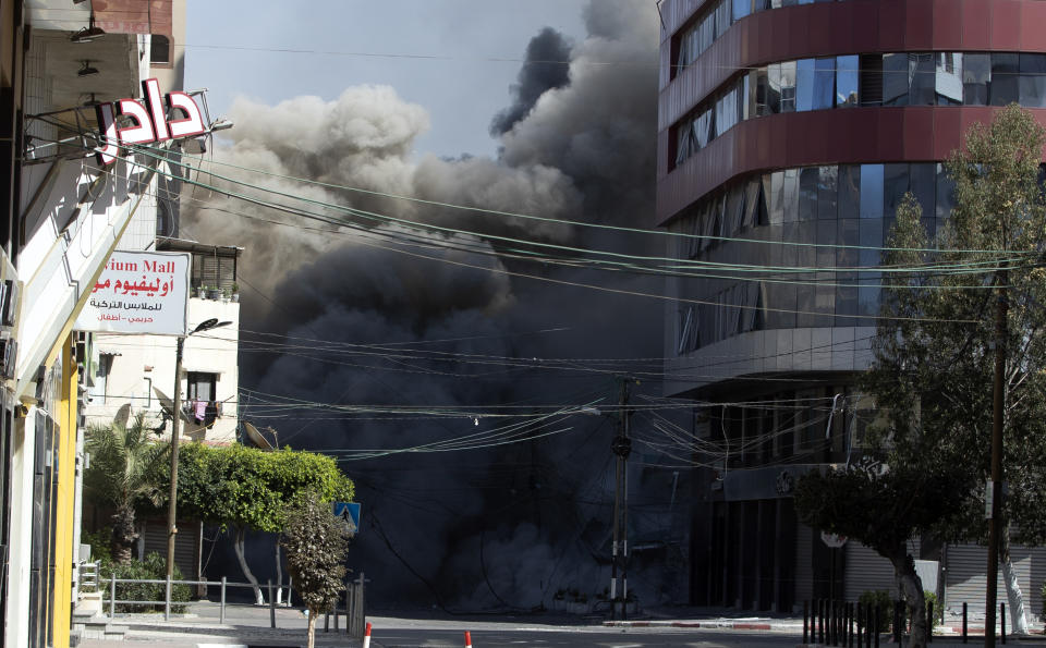 An Israeli airstrike hits the high-rise building that houses The Associated Press' offices in Gaza City, Saturday, May 15, 2021. The airstrike Saturday came roughly an hour after the Israeli military ordered people to evacuate the building. There was no immediate explanation for why the building was targeted. The building housed The Associated Press, Al-Jazeera and a number of offices and apartment. (AP Photo/Khalil Hamra)