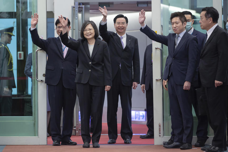 In this photo released by the Taiwan Presidential Office, Taiwan's Presidential office secretary general Lin Chia-lung, left, President Tsai Ing-wen, center, and Foreign Minister Joseph Wu wave before Tsai's departure on an overseas trip at Taoyuan International Airport in Taipei, Taiwan, Wednesday, March 29, 2023. China has threatened "resolute countermeasures" over a planned meeting between Taiwanese President Tsai Ing-wen and Speaker of the United States House Speaker Kevin McCarthy during an upcoming visit in Los Angeles by the head of the self-governing island democracy. (Taiwan Presidential Office via AP)