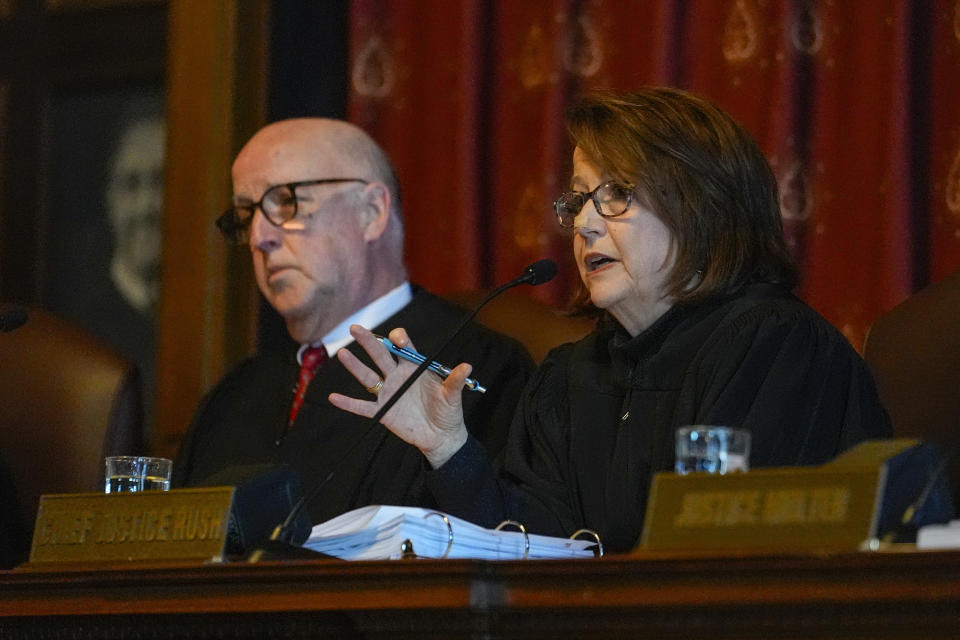 Chief Justice Loretta H. Rush, right, questions an attorney during a hearing before the Indiana Supreme Court at the Statehouse in Indianapolis, Monday, Feb. 12, 2024. GOP Senate candidate, John Rust, who is suing to appear on the primary ballot. A trial judge ruled in December that a state law that stipulates candidates must vote in two primary elections with their party is unconstitutional. The state appealed the ruling. (AP Photo/Michael Conroy, Pool)