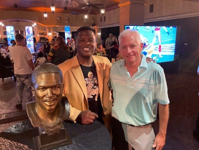 Times-Union sports columnist Gene Frenette, right, with LeRoy Butler and his Pro Football Hall of Fame bust at a HOF celebration party.