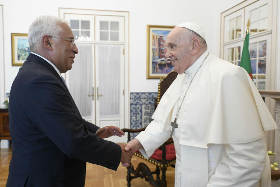 In this image provided by Vatican Media, Pope Francis meets with Portuguese Prime Minister Antonio Costa, left, inside the Vatican Nunciature in Lisbon, Wednesday, Aug. 2, 2023. Pope Francis arrived Wednesday in Lisbon to attend the international World Youth Day on Sunday which is expected to bring hundreds of thousands of young Catholic faithful to Portugal. (Vatican Media via AP, HO)