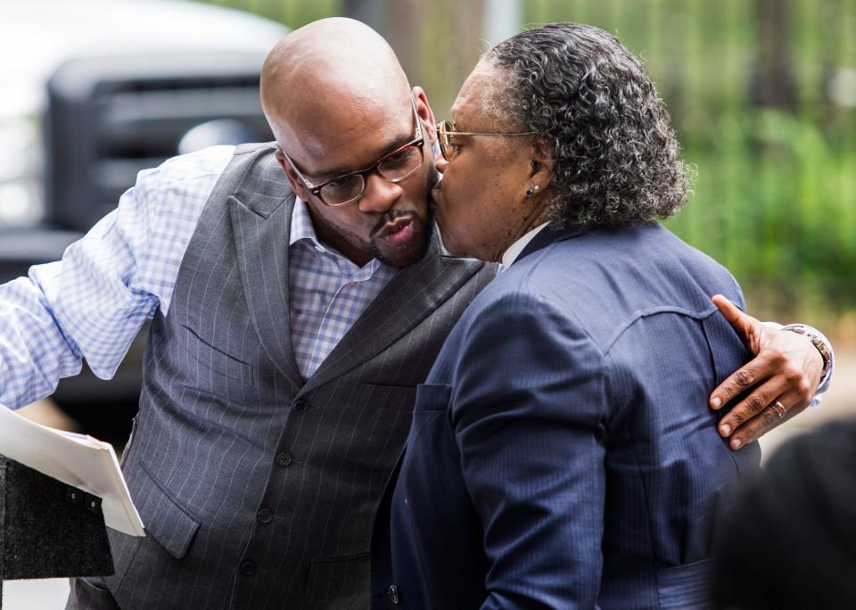 The Rev. Donald Morton gets a kiss from his mother, Bishop Aretha Morton, at a ceremony honoring her outside the Tabernacle Full Gospel Baptist Church in Wilmington on Sunday afternoon.