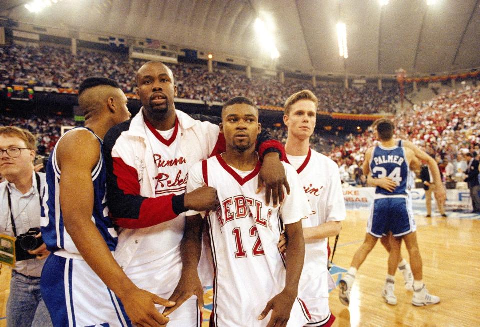 UNLV's Anderson Hunt (12) and teammates leave the floor after losing to Duke in the NCAA national semifinal game in 1991.