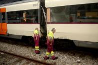 <p>Workers look at a damaged train on the platform of a train station in Barcelona, Spain, Friday, July 28, 2017. (Photo: Adrian Quiroga/AP) </p>
