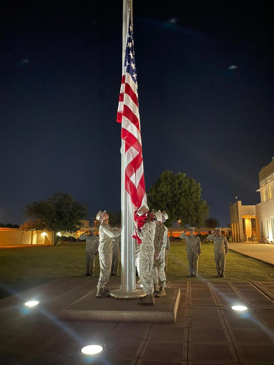 A flag-lowering ceremony takes place at the US embassy in Khartoum before it is evacuated.