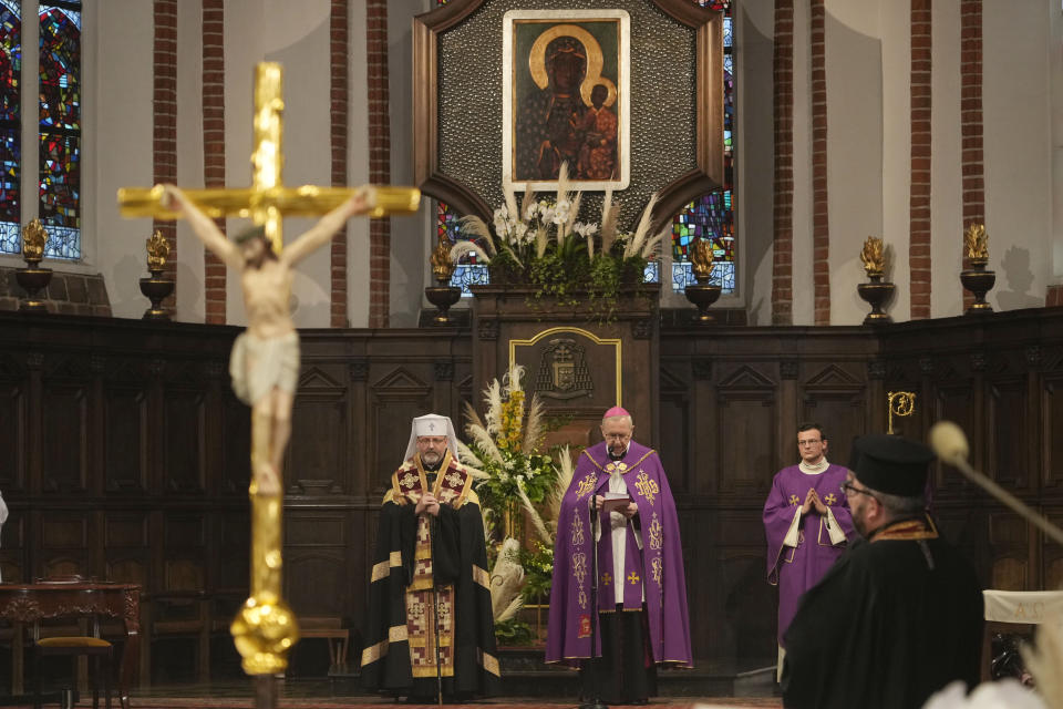 The head of Poland's Roman Catholic Church, Archbishop Stanislaw Gadecki, right, and Archbishop Sviatoslav Shevchuk, left, of the Ukrainian Greek Catholic Church hold a reconciliation religious service as part of observances honoring some 100,000 Poles murdered by Ukrainian nationalists in 1943-44, at St. John's cathedral in Warsaw, Poland, on Friday,July 7, 2023. (AP Photo/Czarek Sokolowski)