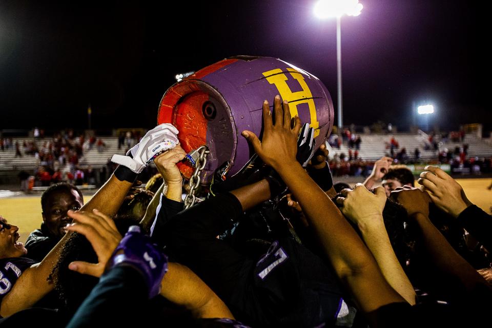 The Male Bulldog players lifted the Barrel in celebration after the Bulldogs defeated the Manual Crimsons 14-3 on Friday night, Oct. 28, 2022