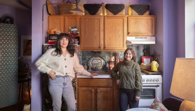 Dwellers standing in apartment kitchen.