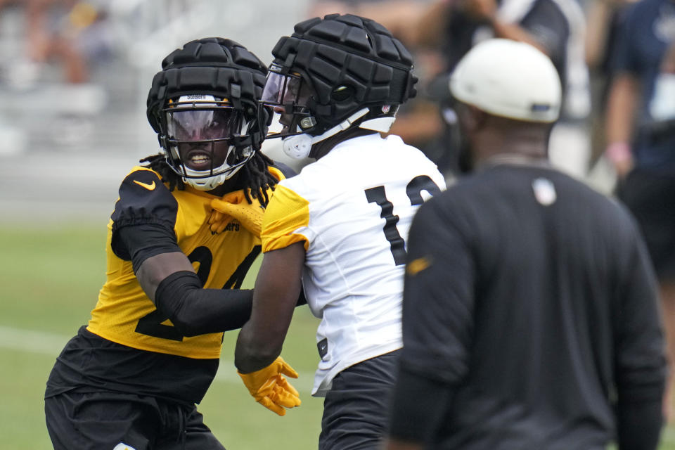Pittsburgh Steelers cornerback Joey Porter Jr., left, defends against wide receiver Miles Boykin, center, as coach Mike Tomlin, right, watches during the NFL football team's training camp in Latrobe, Pa., Thursday, July 27, 2023. (AP Photo/Gene J. Puskar)