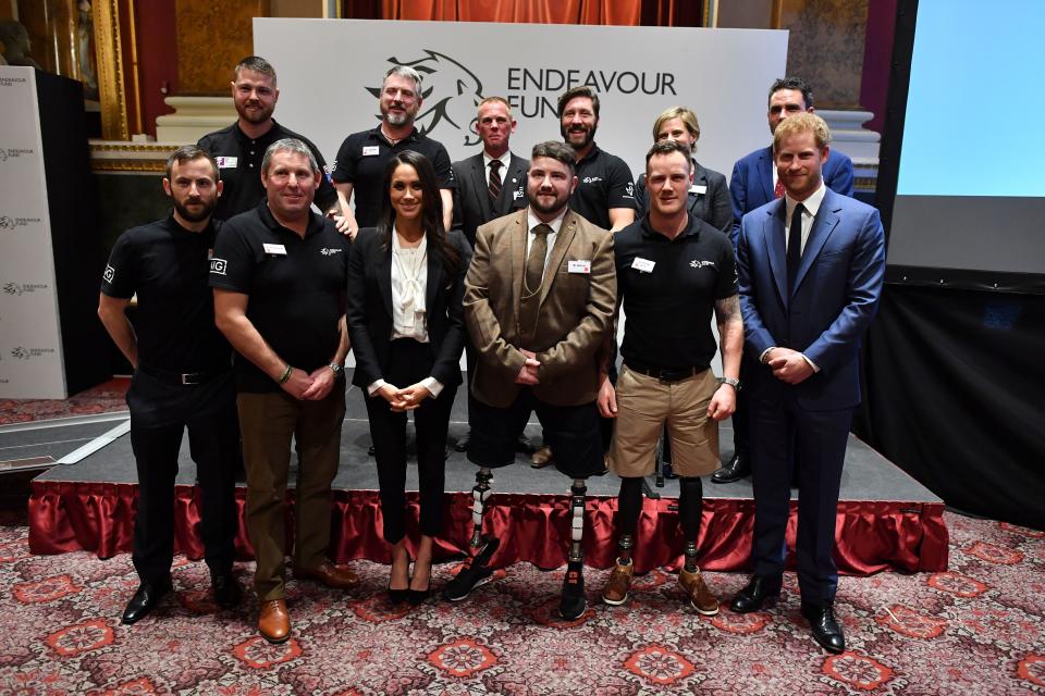 Britain's Prince Harry (front R) and his fiancee US actress Meghan Markle (front 3L) pose with award winners Ben Lee (front 3R), Sean Gane (back 2L) and Daniel Claricoates (back 3L) and the award nominees during the annual Endeavour Fund Awards at Goldsmiths' Hall in London on February 1, 2018.   Prince Harry and Meghan Markle attended the second annual Endeavour Fund Awards ceremony in London. The Endeavour Fund Awards celebrate the achievements of wounded, injured and sick veterans who have taken part in remarkable sporting and adventure challenges as part of their recovery and rehabilitation.  / AFP PHOTO / POOL / Ben STANSALL        (Photo credit should read BEN STANSALL/AFP via Getty Images)