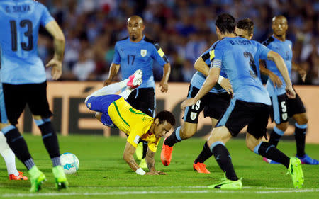 Football Soccer - Uruguay v Brazil - World Cup 2018 Qualifiers - Centenario stadium, Montevideo, Uruguay - 23/3/17 - Brazil's Neymar (in yellow) in action against Uruguay's players. REUTERS/Andres Stapff