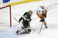 Anaheim Ducks center Ryan Strome, right, prepares to shoot past Minnesota Wild goalie Filip Gustavsson for a goal during the first period of an NHL hockey game Saturday, Dec. 3, 2022, in St. Paul, Minn. (AP Photo/Craig Lassig)