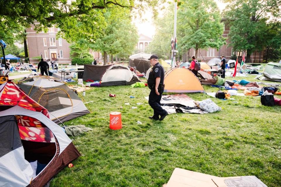 Police officers patrol Polk Place as the “pro-Palestine encampment” is cleared out on Tuesday, April 30. Earlier in the morning arrests were made.