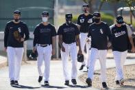 Chicago White Sox players walk to another field during a spring training baseball practice Wednesday, Feb. 24, 2021, in Phoenix. (AP Photo/Ross D. Franklin)