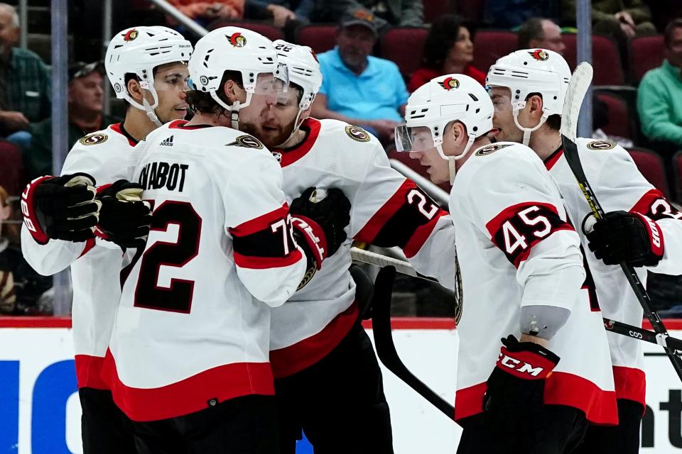 Ottawa Senators left wing Parker Kelly (45) celebrates his goal against the Arizona Coyotes with Senators defenseman Artem Zub, left, defenseman Thomas Chabot, second from left, right wing Connor Brown (28) and center Dylan Gambrell, right, during the second period of an NHL hockey game Saturday, March 5, 2022, in Glendale, Ariz. (AP Photo/Ross D. Franklin)