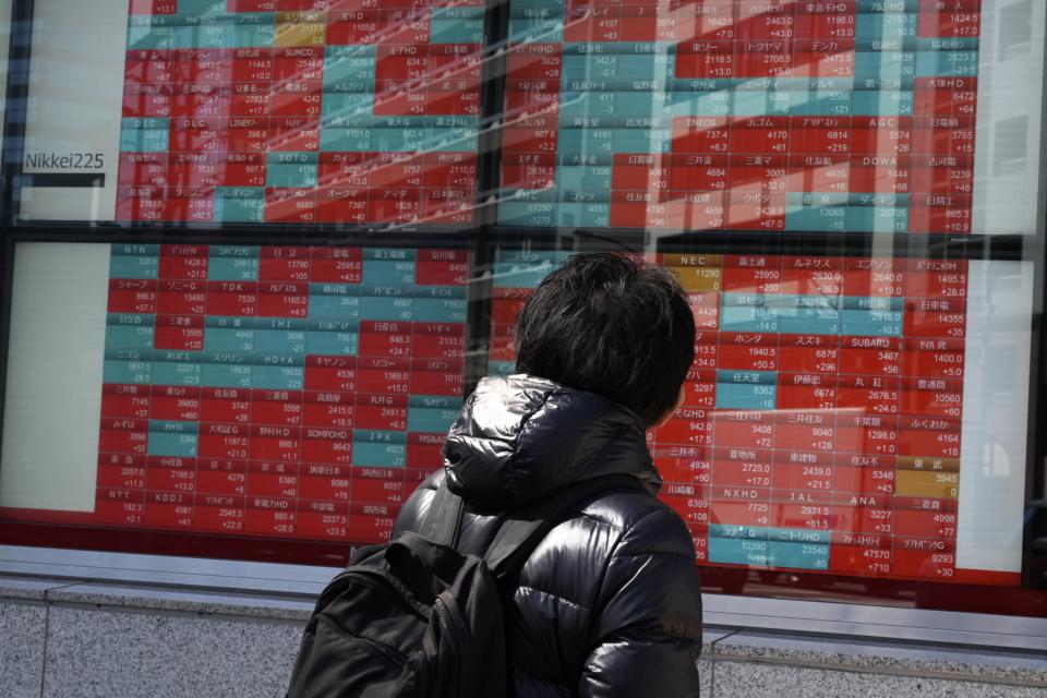 FILE - A person looks at an electronic stock board showing Japan's stock prices at a securities firm in Tokyo, March 22, 2024. Asia stocks were mostly higher on Tuesday, April 9, 2024, with investors mainly focusing on a U.S. inflation report and what it means for interest rate cuts by the Federal Reserve.(AP Photo/Eugene Hoshiko, File)