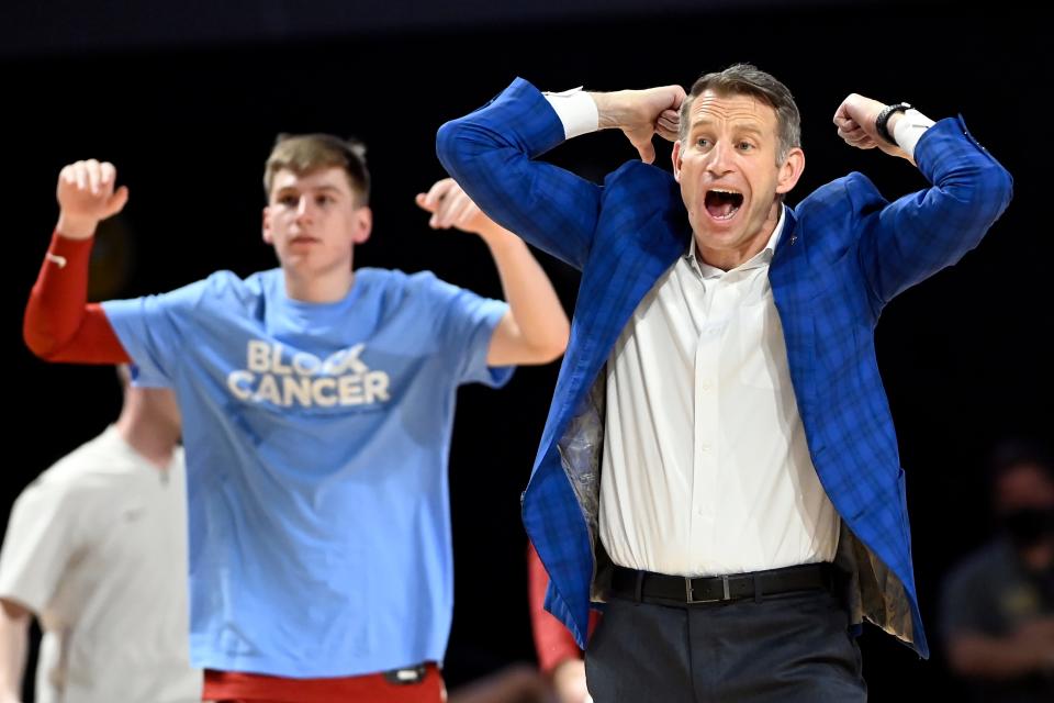 Alabama head coach Nate Oats, right, celebrates with guard Britton Johnson standing behind him after a time out was called during the second half of an NCAA college basketball game against Vanderbilt on Tuesday, Feb. 22, 2022, in Nashville, Tenn. Alabama won 74-72. (AP Photo/Mark Zaleski)