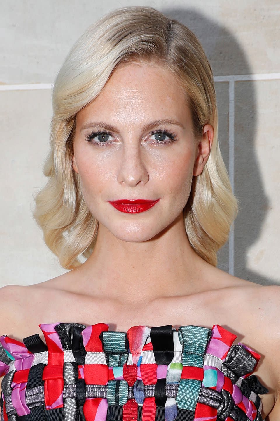 <p>When wearing glossy red lipstick like Poppy Delevingne the trick is to keep the rest of your make-up minimal. Use tinted moisturiser or IT Cosmetics' <a rel="nofollow noopener" href="https://www.itcosmetics.co.uk/face/foundation/your-skin-but-better-cc-cream-with-spf-50/817919015519.html?gclid=CjwKCAjwg_fZBRAoEiwAppvp-UPhw_Dieo8D1aLsHeiuZrQxH3nQ2IvhIX2zUNSYWf0QQxBm-rqkzxoC5KcQAvD_BwE&gclsrc=aw.ds" target="_blank" data-ylk="slk:Your Skin But Better CC Cream;elm:context_link;itc:0;sec:content-canvas" class="link ">Your Skin But Better CC Cream</a>, £30, instead of foundation and apply Dior's <a rel="nofollow noopener" href="https://www.dior.com/beauty/en_gb/fragrance-beauty/makeup/eyes/mascaras/pr-mascaras-y0697400_f069740090-lash-extension-effect-volume-mascara.html?LGWCODE=F069740090GB;143909;6271&gclid=CjwKCAjwg_fZBRAoEiwAppvp-RuoTk5oeGR2KDFxS5vQP1JvFlUl7l5d1CA9dTxerlWBr_cIJLaISBoCpt8QAvD_BwE" target="_blank" data-ylk="slk:Diorshow Mascara;elm:context_link;itc:0;sec:content-canvas" class="link ">Diorshow Mascara</a>, £27, without obvious eyeliner to define your eyes. Then, for maximum impact, apply Giorgio Armani's <a rel="nofollow noopener" href="https://www.feelunique.com/p/Giorgio-Armani-Lip-Maestro-6-5ml?option=27050&gclid=CjwKCAjwg_fZBRAoEiwAppvp-XqGyREB3Q1TmBPnhuI1wxUUaSPR0k9M74PFey0zv9BFFC14LvsdWBoCTa0QAvD_BwE&gclsrc=aw.ds" target="_blank" data-ylk="slk:Lip Maestro in The Red;elm:context_link;itc:0;sec:content-canvas" class="link ">Lip Maestro in The Red</a>, £21, with a lip brush for a flawless, statement pout. <br></p>