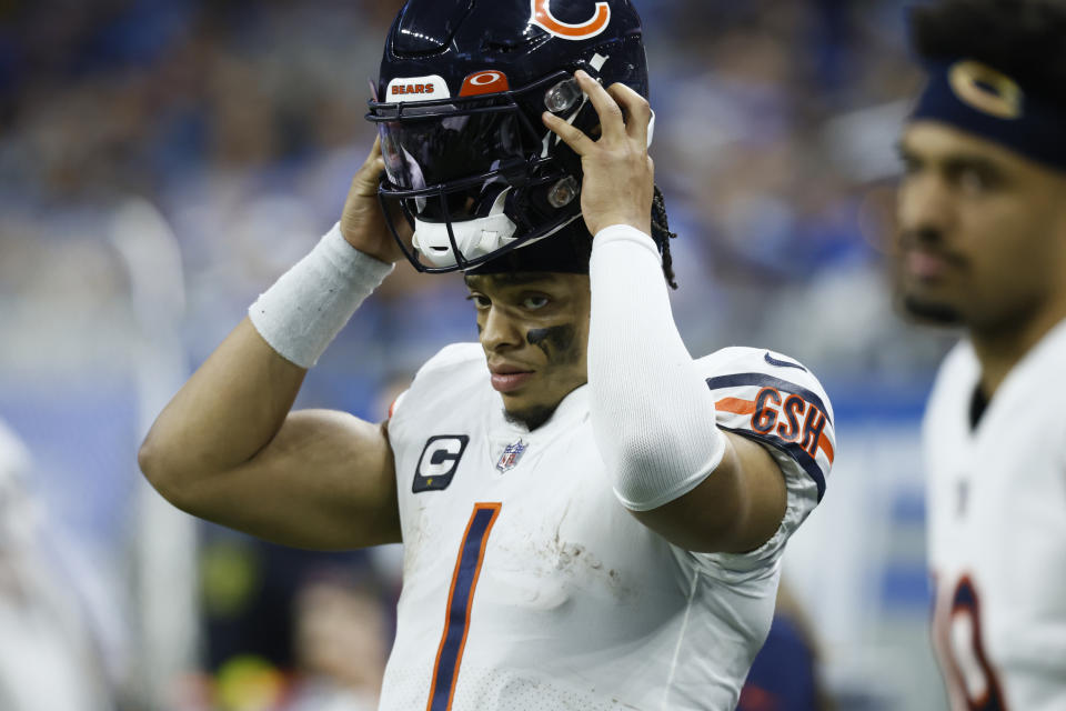 Chicago Bears quarterback Justin Fields puts on his helmet during the second half of an NFL football game against the Detroit Lions, Sunday, Jan. 1, 2023, in Detroit. (AP Photo/Duane Burleson)