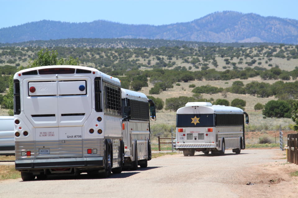 A transport bus pulls away from a privately-run detention center in Milan, New Mexico, on Wednesday, June 12, 2019. The facility is home to the only permanent dedicated unit for transgender migrants in the custody of U.S. Immigration and Customs Enforcement. (AP Photo/Susan Montoya Bryan)