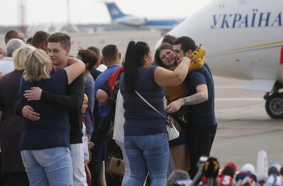 Relatives of Ukrainian prisoners freed by Russia greet them upon their arrival at Boryspil airport, outside Kyiv, Ukraine, Saturday, Sept. 7, 2019. Planes carrying prisoners freed by Russia and Ukraine have landed in the countries' capitals, in an exchange that could be a significant step toward improving relations between Moscow and Kyiv. The planes, each reportedly carrying 35 prisoners, landed almost simultaneously at Vnukovo airport in Moscow and at Kyiv's Boryspil airport. (AP Photo/Efrem Lukatsky)