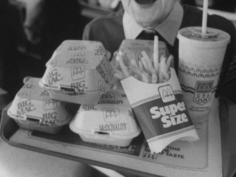 A woman holds a tray of McDonald's food circa 1988