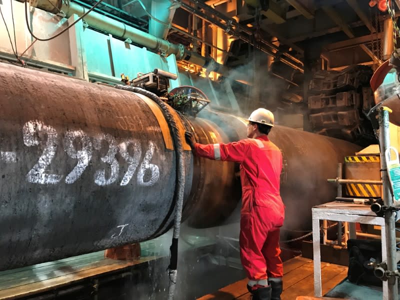 FILE PHOTO: A specialist works onboard the Allseas' deep sea pipe laying ship Solitaire to prepare a pipe for Nord Stream 2 pipeline in the Baltic Sea