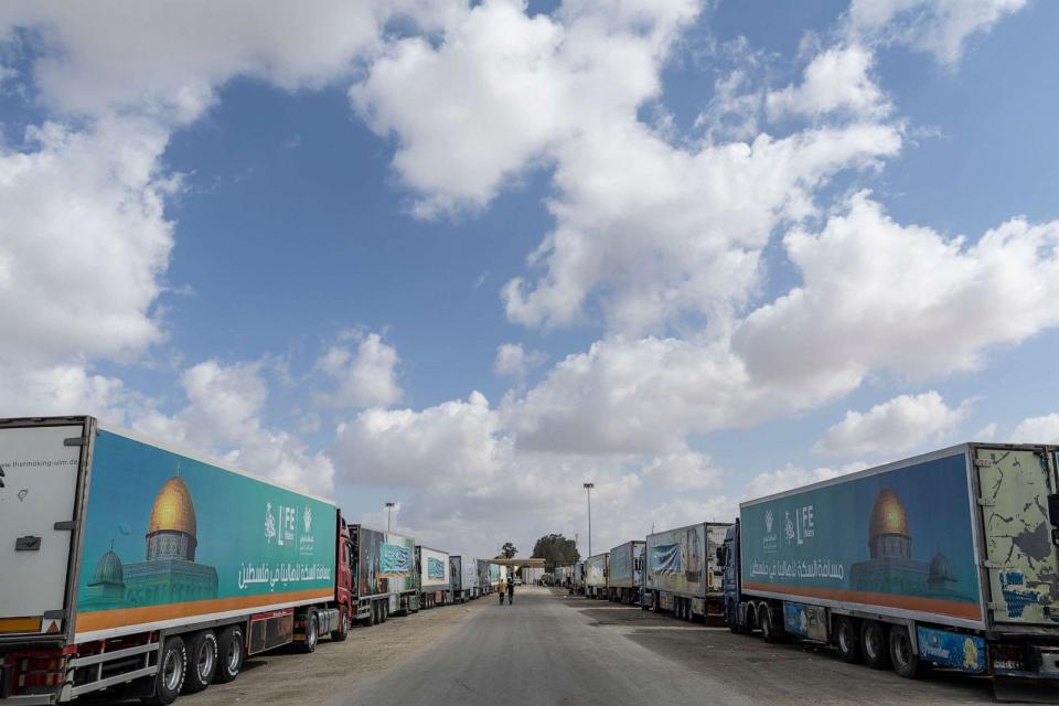 PHOTO: Aid convoy trucks wait at the Rafah border crossing for clearance to enter Gaza on Oct. 19, 2023 in North Sinai, Egypt. (Mahmoud Khaled/Getty Images)