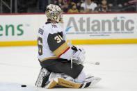 Vegas Golden Knights goaltender Logan Thompson watches as the New Jersey Devils celebrate after New Jersey Devils defenseman Dougie Hamilton scored the winning goal in overtime of an NHL hockey game, Tuesday, Jan. 24, 2023, in Newark, N.J. The Devils won 3-2. (AP Photo/Mary Altaffer)