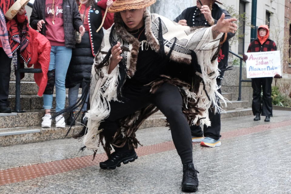 Jarrell Williams dances in a Raven's Tail robe to the Women's Warrior Song, written by Martina Pierre, on the Capitol steps in Juneau on May 5, 2024. (Photo by Claire Stremple/Alaska Beacon)