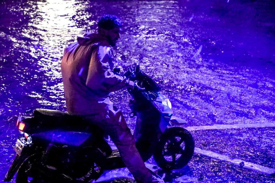 Motorcyclist sees flooding on 10th street in Brickell right after midnight on Nov. 16, 2023, and decides to turn around and go a different direction instead of attempting to drive through the water. Thanksgiving and Black Friday a week later will not be a repeat, the National Weather Service in Miami says.