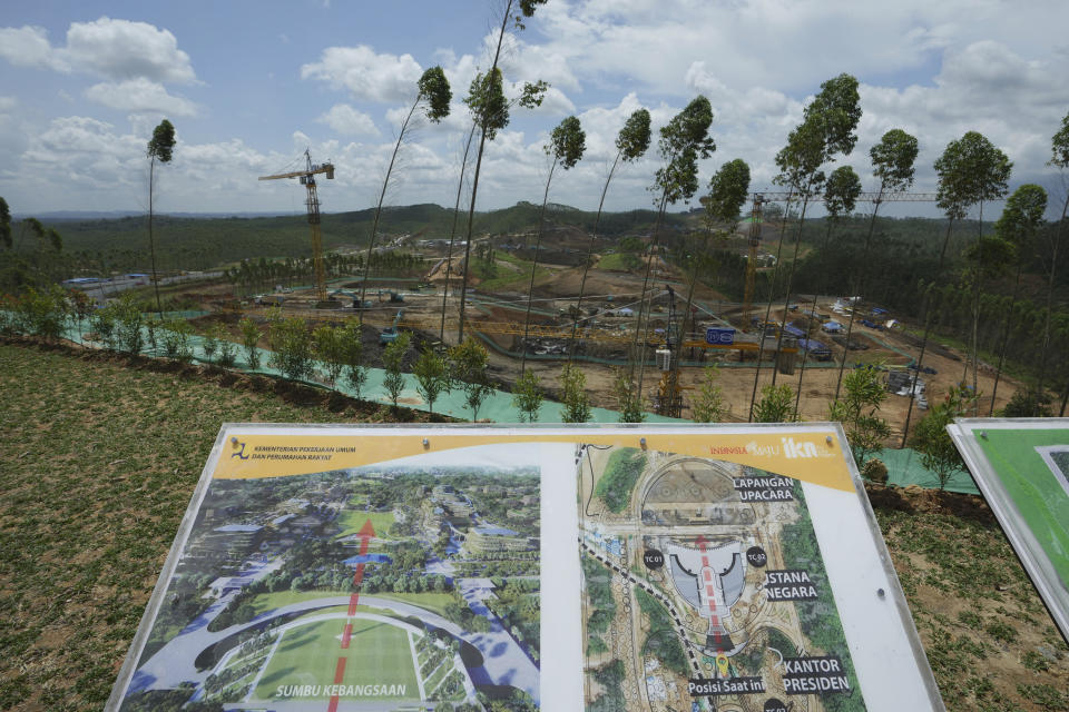 A digital rendering showing the lay out of presidential palace compound at the new capital city are displayed at its construction site in Penajam Paser Utara, East Kalimantan, Indonesia, Wednesday, March 8, 2023. Indonesia began construction of the new capital in mid 2022, after President Joko Widodo announced that Jakarta — the congested, polluted current capital that is prone to earthquakes and rapidly sinking into the Java Sea — would be retired from capital status. (AP Photo/Achmad Ibrahim)