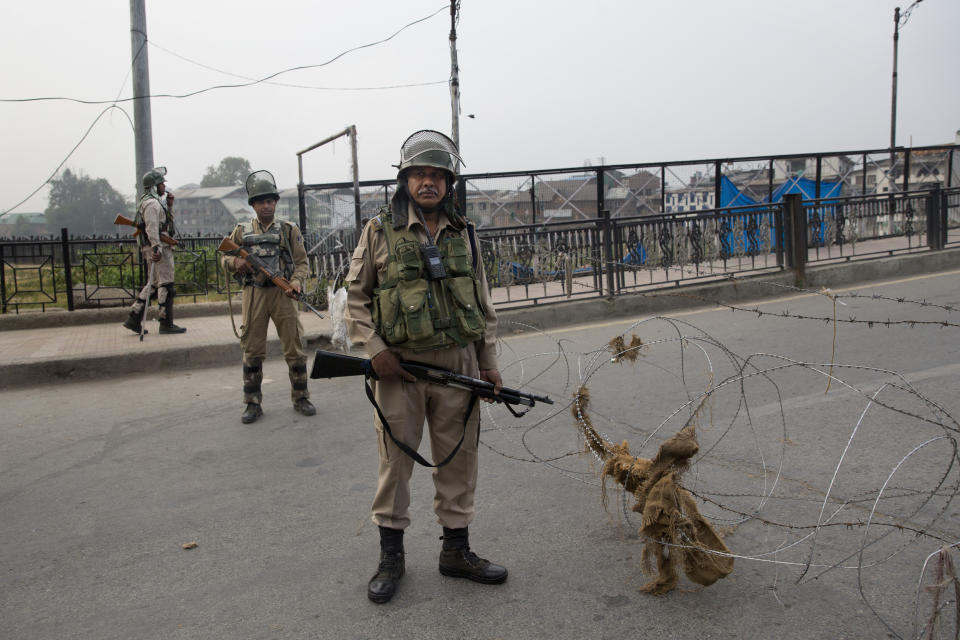 Indian paramilitary force soldiers stand guard during restrictions in Srinagar Indian controlled Kashmir, Friday, Sept. 27, 2019. Residents in Indian-controlled Kashmir waited anxiously as Indian and Pakistani leaders were scheduled to speak at the U.N. General Assembly later Friday. (AP Photo/ Dar Yasin)