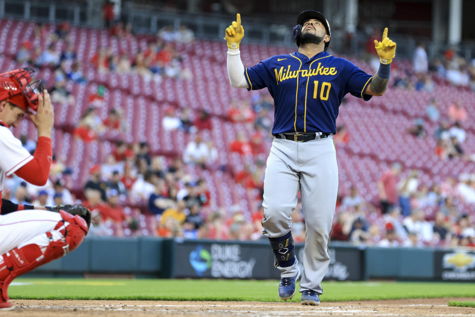 Milwaukee Brewers' Omar Narvaez points to the sky as he crosses home plate after hitting a solo home run during the fifth inning of a baseball game against the Cincinnati Reds in Cincinnati, Monday, May 9, 2022. (AP Photo/Aaron Doster)