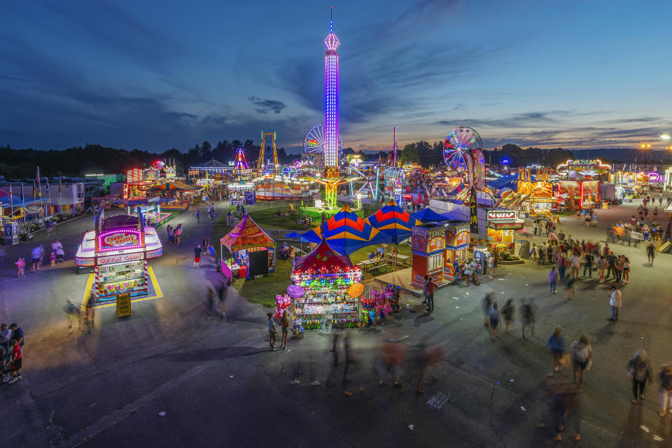 FILE - In this Aug. 9, 2018, file photo, fair-goers attend The State Fair of West Virginia at the State Fairgrounds in Fairlea, W.Va. West Virginia has seen a higher percentage of residents depart than any other state in the past decade. (Craig Hudson/Charleston Gazette-Mail via AP, File)