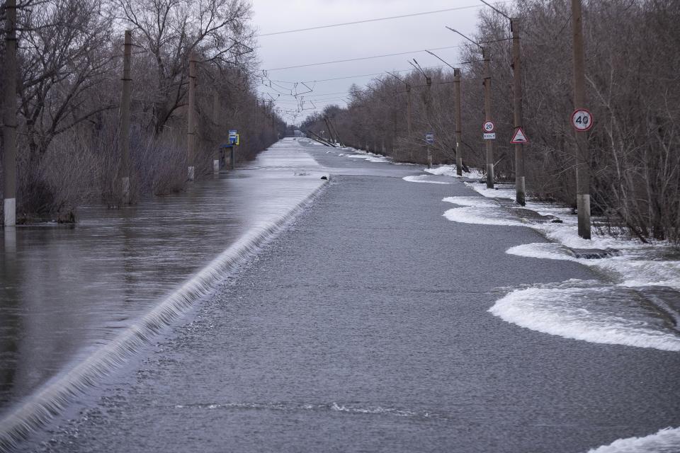 Water floods the highway between the upper and lower parts of the city after a part of a dam burst, in Orsk, Russia on Monday, April 8, 2024. Floods caused by rising water levels in the Ural River broke a dam in a city near Russia's border with Kazakhstan, forcing some 2,000 people to evacuate, local authorities said. The dam broke in the city of Orsk in the Orenburg region, less than 12.4 miles north of the border on Friday night, according to Orsk mayor Vasily Kozupitsa. (AP Photo)