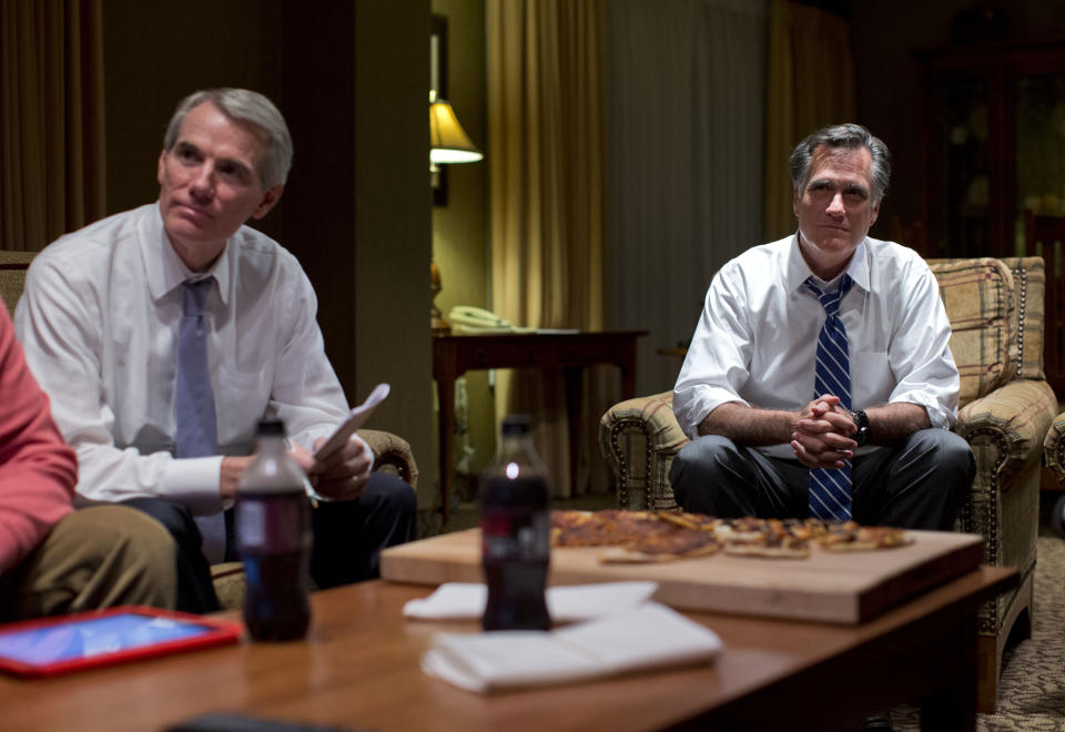 Republican presidential candidate, former Massachusetts Gov. Mitt Romney, right, watches the vice presidential debate with Sen. Rob Portman, R- Ohio, left, in his hotel room on Thursday, Oct. 11, 2012 in Asheville, N.C. (AP Photo/ Evan Vucci)