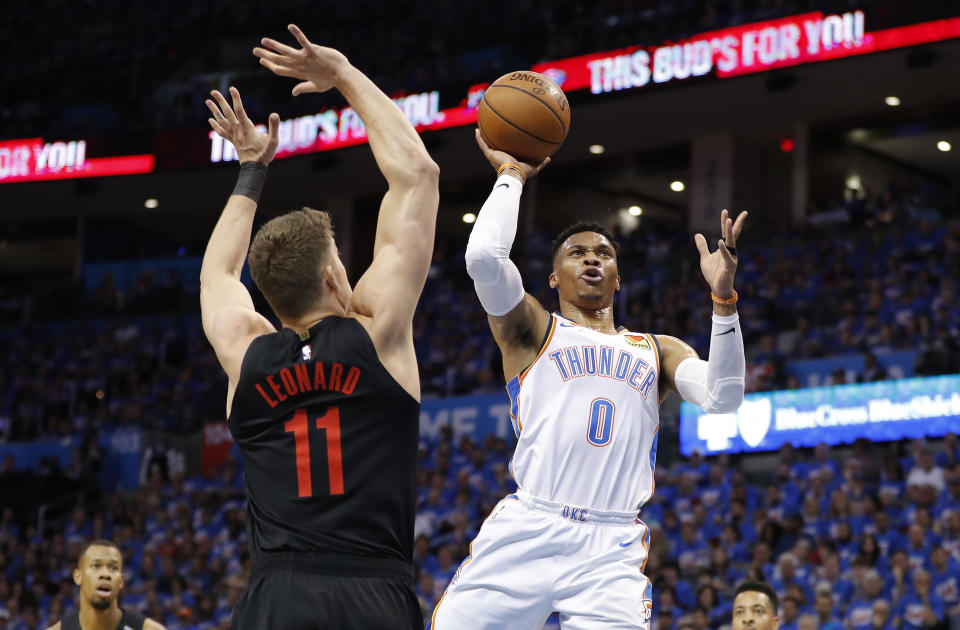 Oklahoma City Thunder guard Russell Westbrook (0) goes to the basket as Portland Trail Blazers forward Meyers Leonard (11) defends in the first half of Game 4 of an NBA basketball first-round playoff series Sunday, April 21, 2019, in Oklahoma City. (AP Photo/Alonzo Adams)