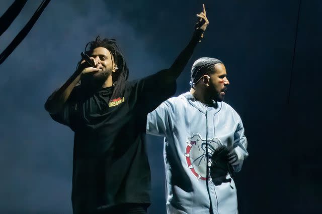 <p>Astrida Valigorsky/WireImage</p> J. Cole (L) and Drake (R) perform during the Dreamville Festival at Dorothea Dix Park in April 2023